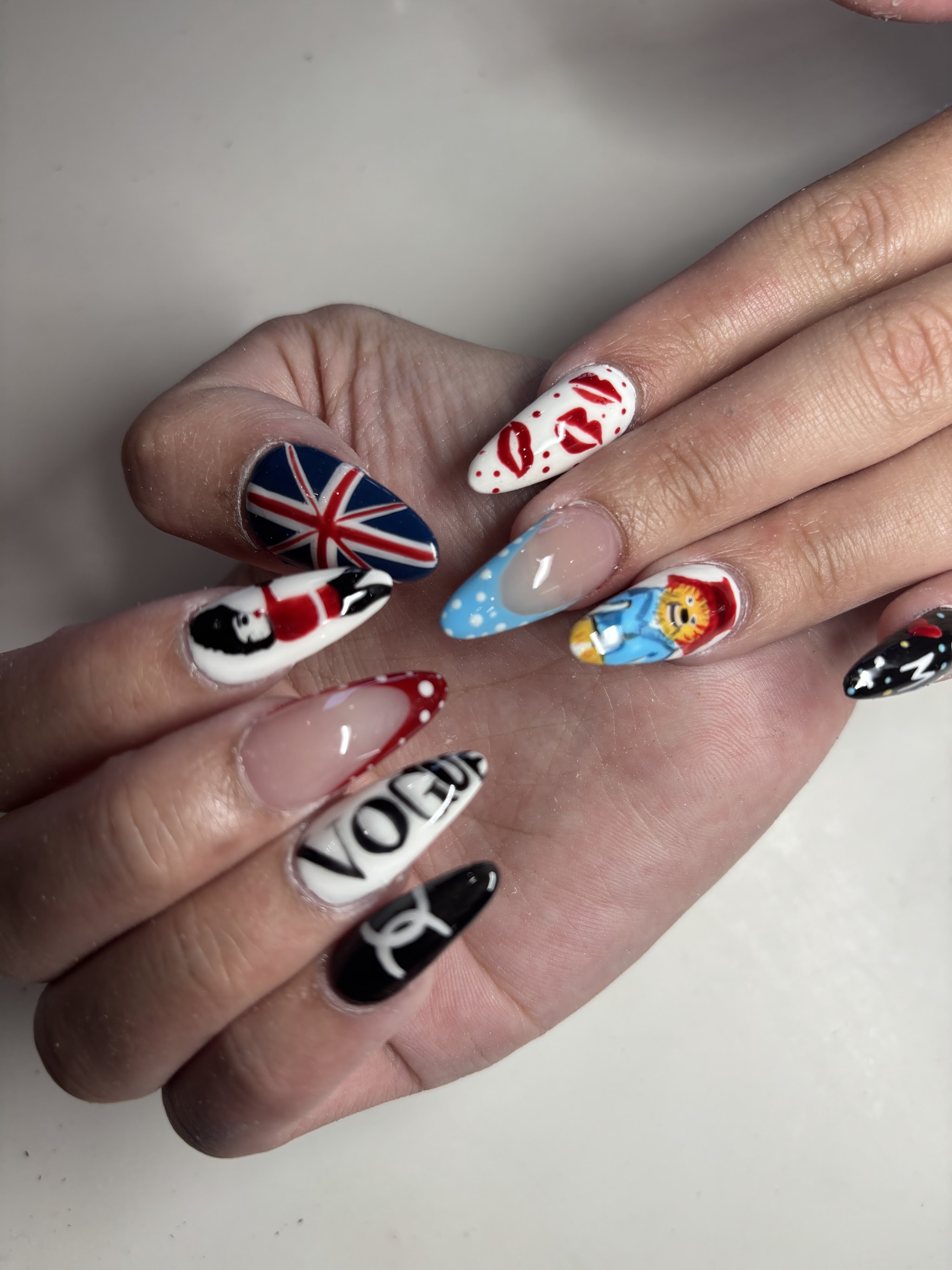 Hand painted nail art with a Union Jack, lips and fashion motifs