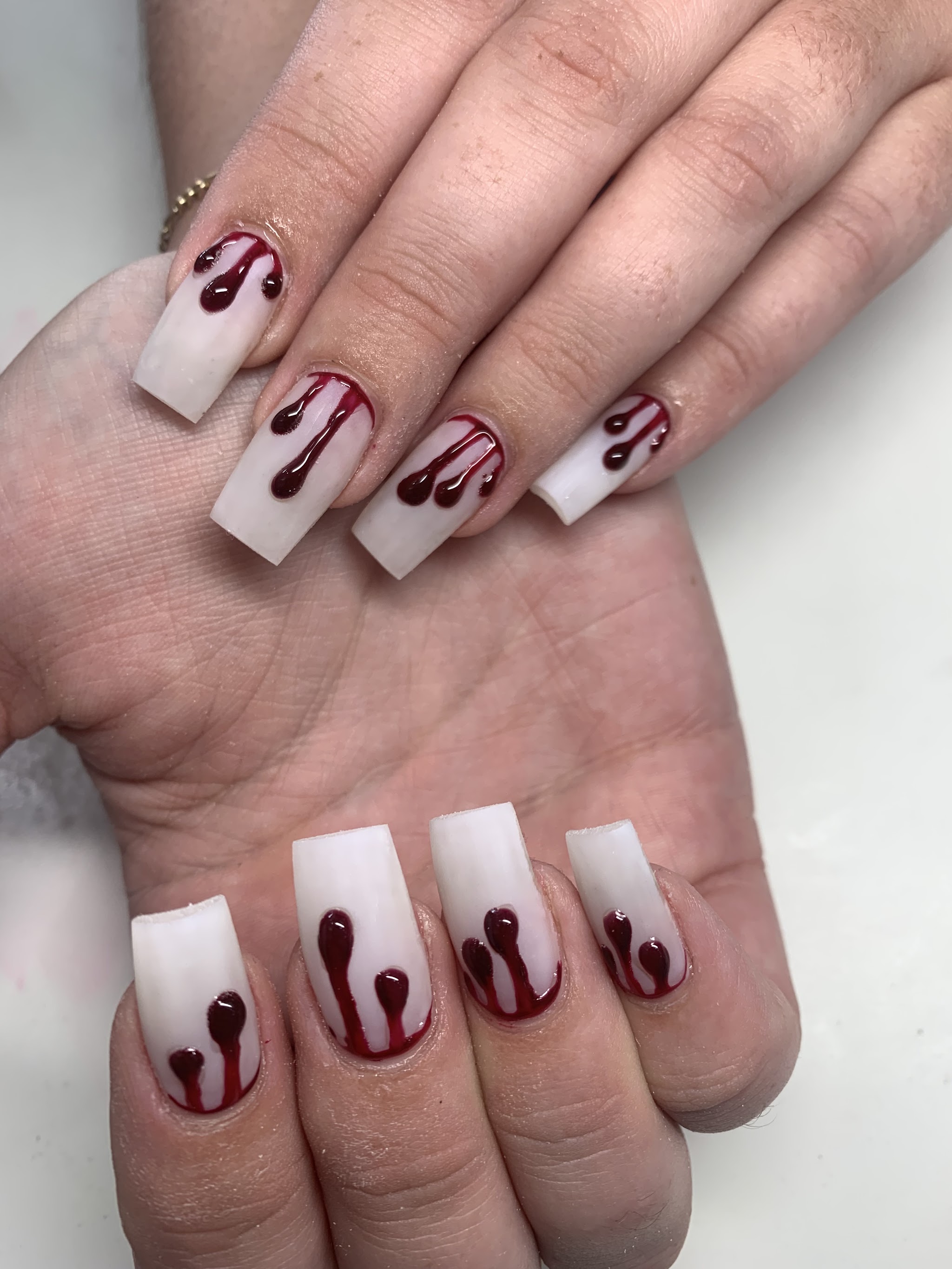 White square nails with dark red drip design
